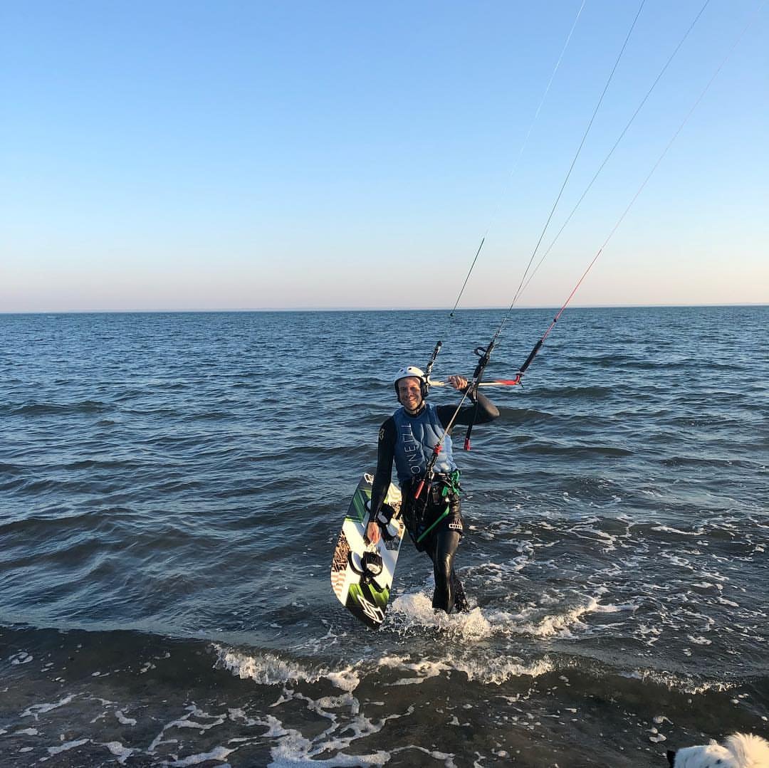 Johannes Herold comes out of the Baltic Sea at Pelzerhaken with kite and board