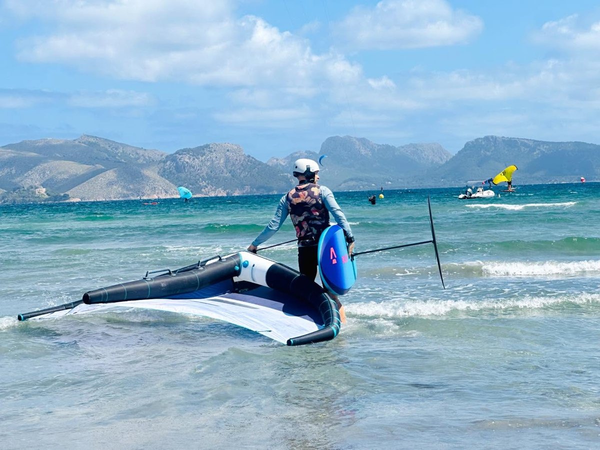 Johannes Herold heads out onto the water with wing and board in the Bay of Pollença
