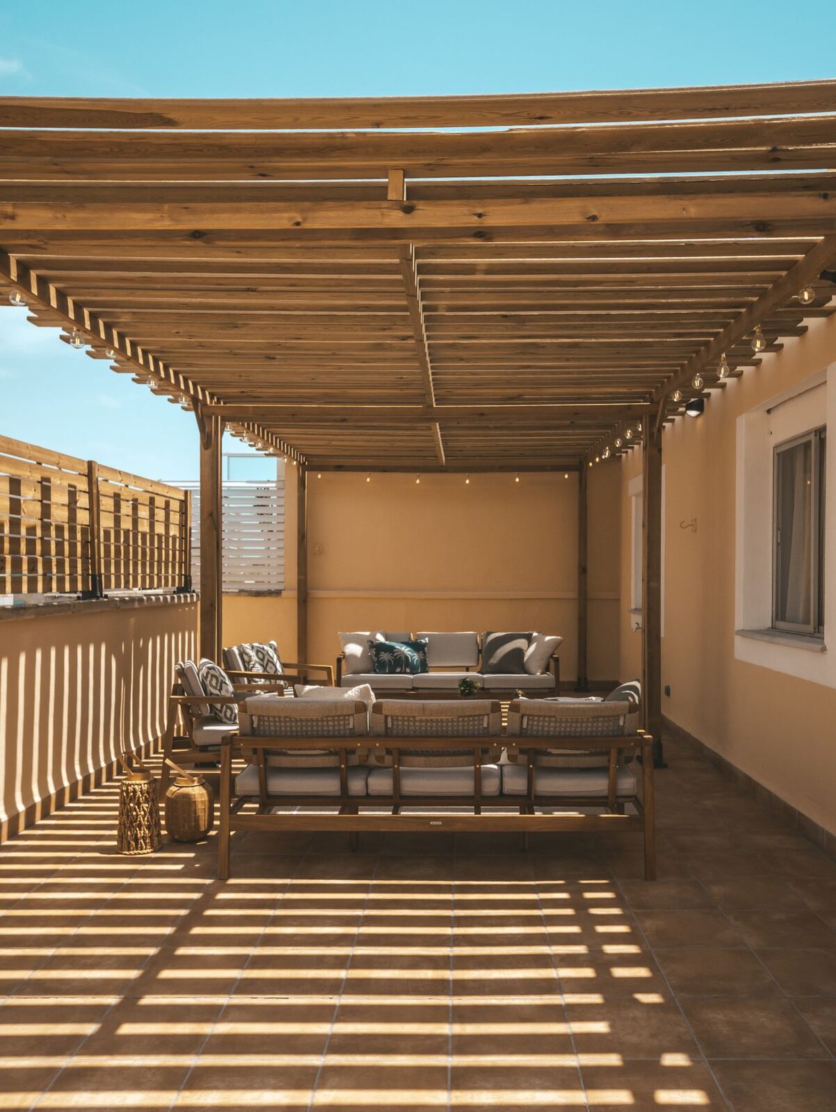 Überdachte Dachterrasse mit Pergola und Sitzecke